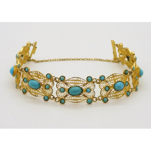 2701 - A FILIGREE AND TURQUOISE BRACELETmade in bright yellow metal stamped with Arabic marks verso and 750... 