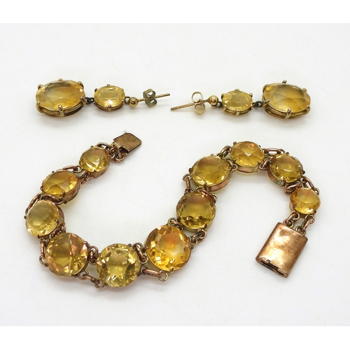 2703 - A CITRINE BRACELETset with round facet cut citrines that taper gently from 12.3mm to 8.4mm, with 9ct... 