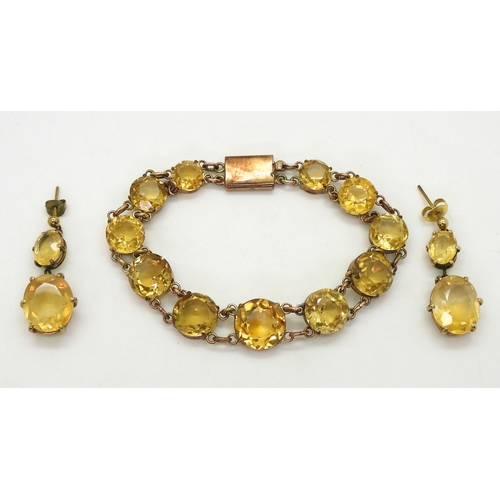 2703 - A CITRINE BRACELETset with round facet cut citrines that taper gently from 12.3mm to 8.4mm, with 9ct... 