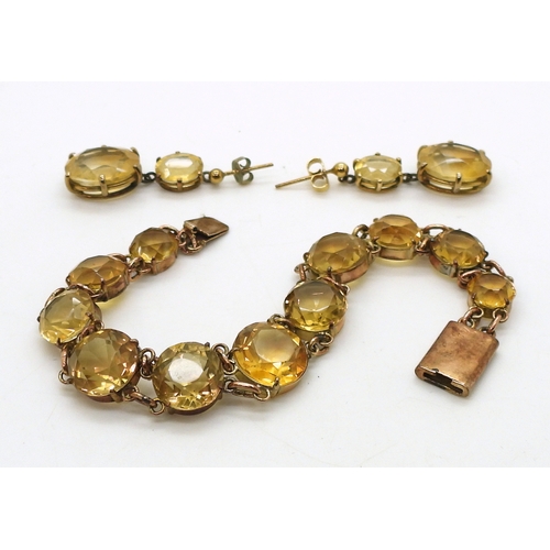 2703 - A CITRINE BRACELETset with round facet cut citrines that taper gently from 12.3mm to 8.4mm, with 9ct... 