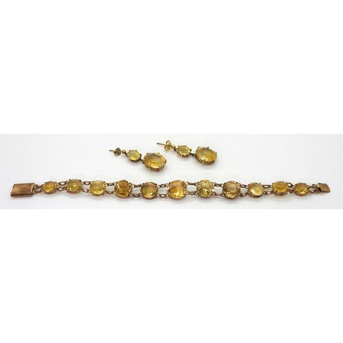 2703 - A CITRINE BRACELETset with round facet cut citrines that taper gently from 12.3mm to 8.4mm, with 9ct... 