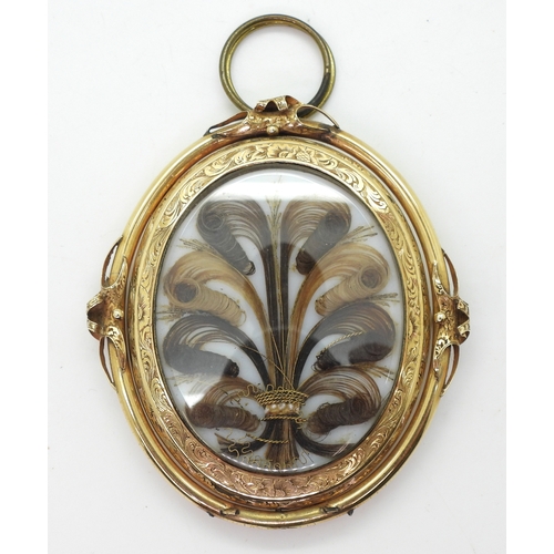 2707 - MOURNING PENDANT BROOCHwith glazed hair art panel, embellished with gold thread and pearls, in flowe... 