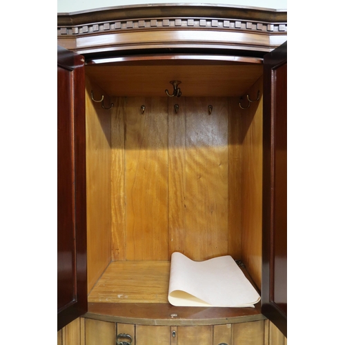 101 - An Edwardian mahogany compactum wardrobe with dentil cornice over pair of bow fronted doors over fou... 