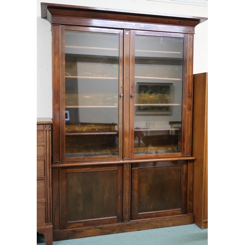 106 - A Victorian rosewood veneered glazed bookcase with moulded cornice over pair of glazed doors on base... 