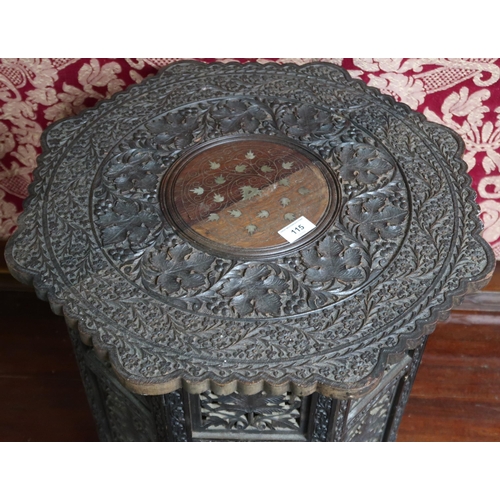 115 - A 20th century extensively carved Anglo-Indian style octagonal topped occasional table with foliate ... 