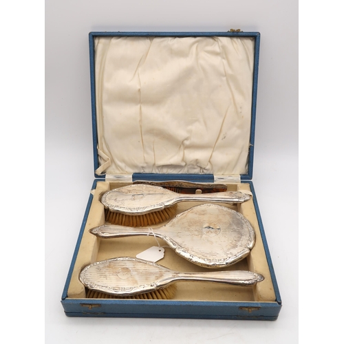 375 - A cased four piece silver dressing set, William Vale & Sons, Chester 1923, comprising two h... 