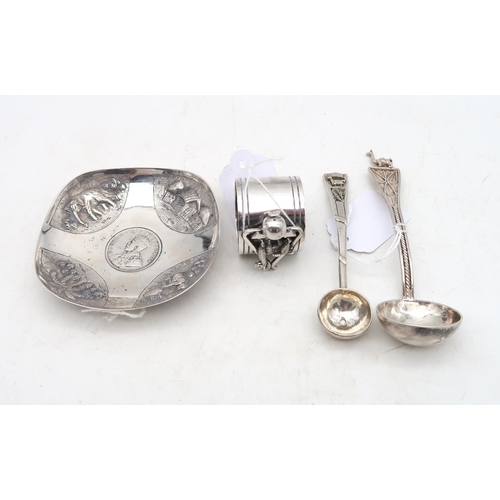 383 - A Peruvian white metal napkin ring, decorated with a llama, a white metal ladle and scoop, the finia... 