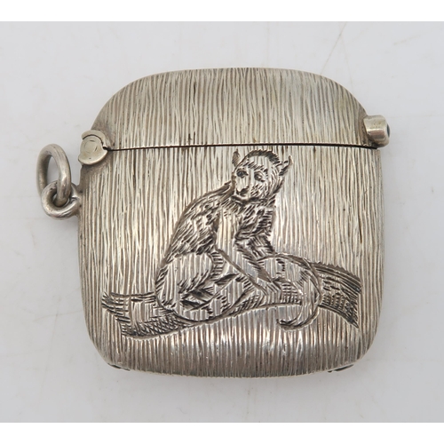 384 - A continental silver vesta, with horizontal banded decoration, engraved with a monkey on a branch, a... 