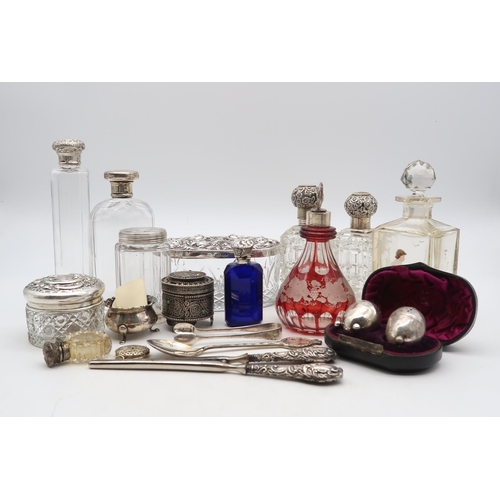 385 - A collection of silver and plate including silver topped cut glass scent bottles, including one by C... 