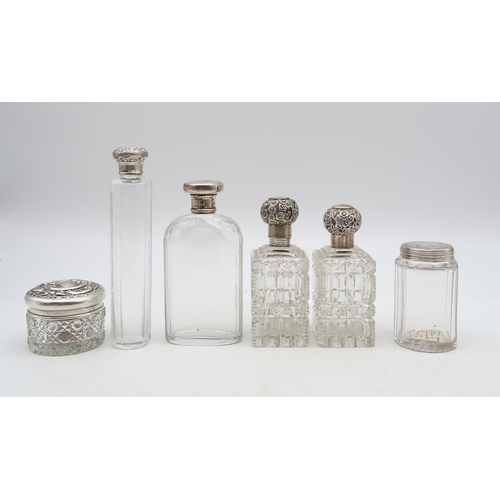 385 - A collection of silver and plate including silver topped cut glass scent bottles, including one by C... 