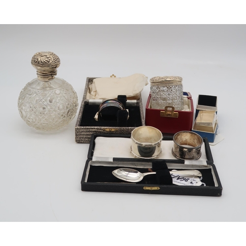 386A - A collection of silver including a silver topped cut glass scent bottle, Birmingham, a silver topped... 