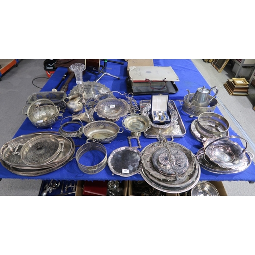 387 - A collection of EPNS including serving trays, a mirror in the shape of a fan, swing handled baskets,... 