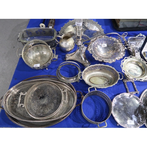 387 - A collection of EPNS including serving trays, a mirror in the shape of a fan, swing handled baskets,... 