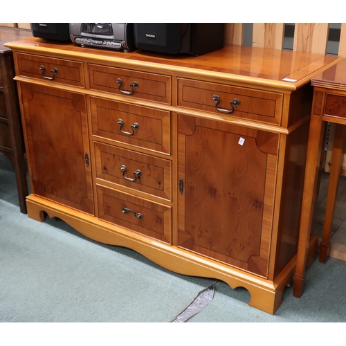 60 - A lot of a 20th century yew wood sideboard with three short drawers over three drawers flanked by ca... 