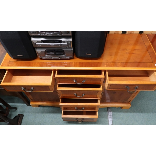 60 - A lot of a 20th century yew wood sideboard with three short drawers over three drawers flanked by ca... 