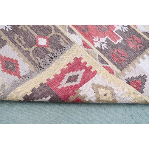 72 - A multicoloured ground tribal Kilim rug with geometric patterned ground, 188cm long x 123cm wide