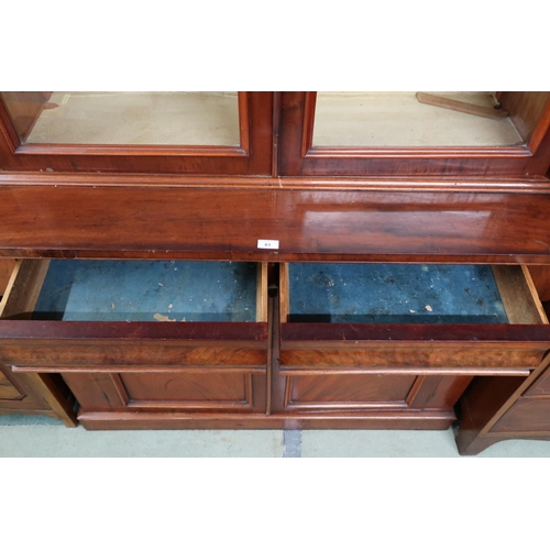 83 - A Victorian mahogany bookcase with moulded cornice over pair of glazed doors on base with two drawer... 