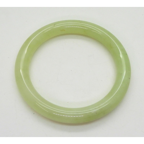 736 - A Chinese green hardstone bangle, inner diameter 6.5cm