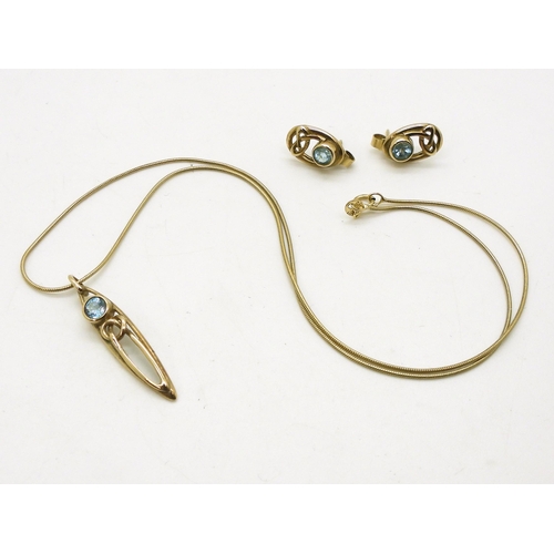 740 - A 9ct gold celtic knot and blue topaz pendant and earring set by Ortak. Weight 5.7gms