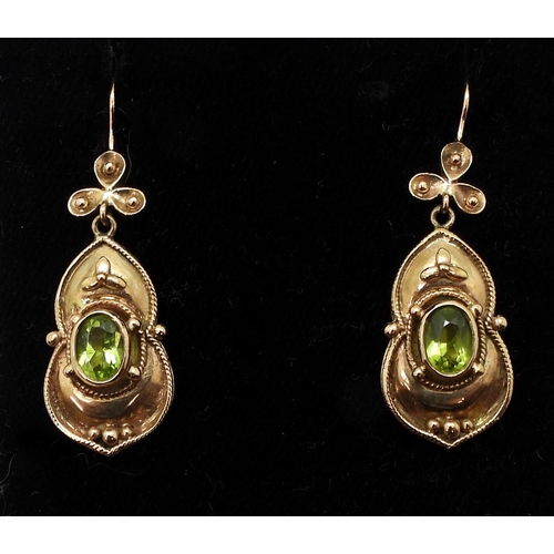 741 - A pair of yellow metal peridot earrings, length 4.2cm, weight 8gms