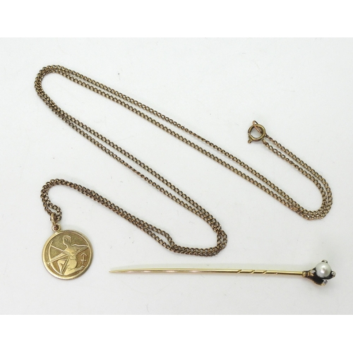 742 - A German 8ct gold Sagittarius pendant and 64cm chain, together with a yellow metal eagle's claw lape... 