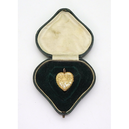 766 - A 9ct gold heart shaped locket with all over flowers & leaves engraving, hallmarked Birmingham 1... 