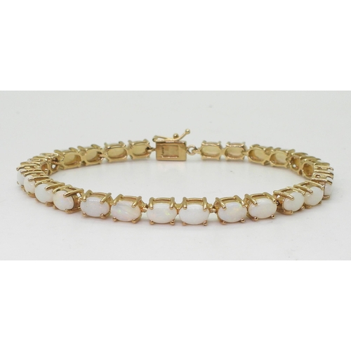 799 - A 9ct gold white opal bracelet, length 18.5cm, weight 11.6gms