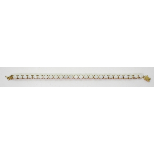 799 - A 9ct gold white opal bracelet, length 18.5cm, weight 11.6gms