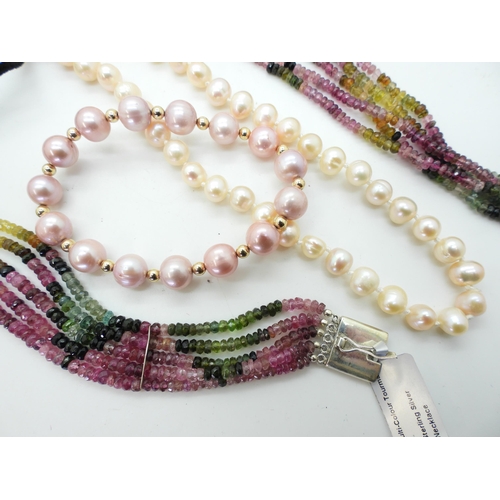 838 - A multi strand multi colour tourmaline bead necklace and matching bracelet, a long string of peach p... 