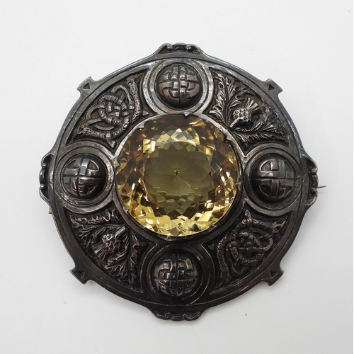 856 - A large silver Scottish plaid brooch with knotwork creatures and thistles, set with a 3.4cm diameter... 