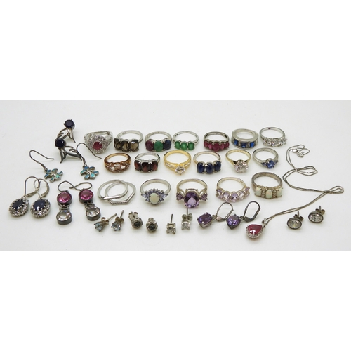 881 - A collection of silver and white metal rings and earrings set with gems and gemstones to include, bl... 