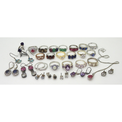 881 - A collection of silver and white metal rings and earrings set with gems and gemstones to include, bl... 