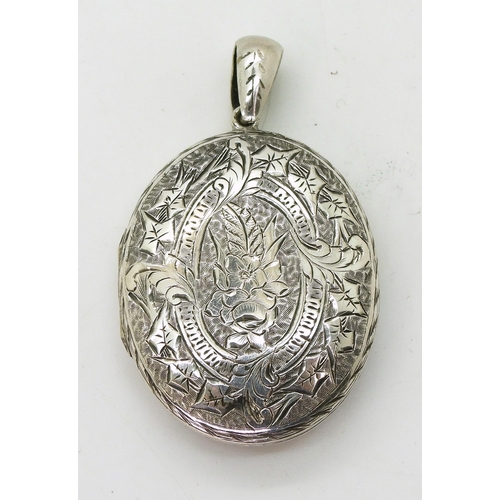 884 - A white metal large locket engraved all over with flowers and leaves, dimensions 5.5cm x 3.2cm