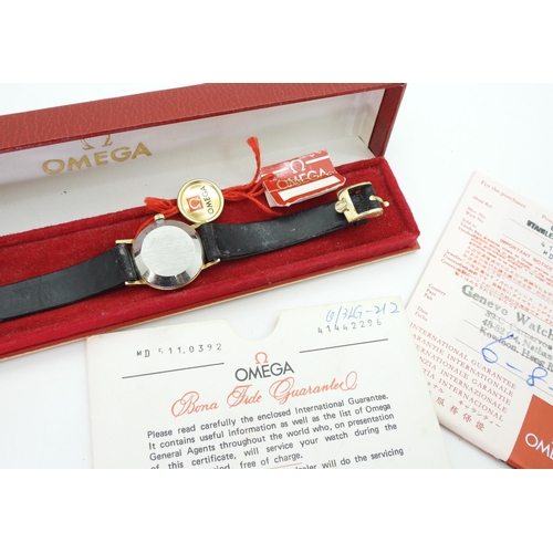 885 - A ladies gold plated Omega watch in original box, with swing tag and guarantee dated 1979