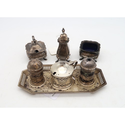 368A - A silver cruet set and stand, by Adie Brothers, Birmingham, with geometric openwork, and another thr... 