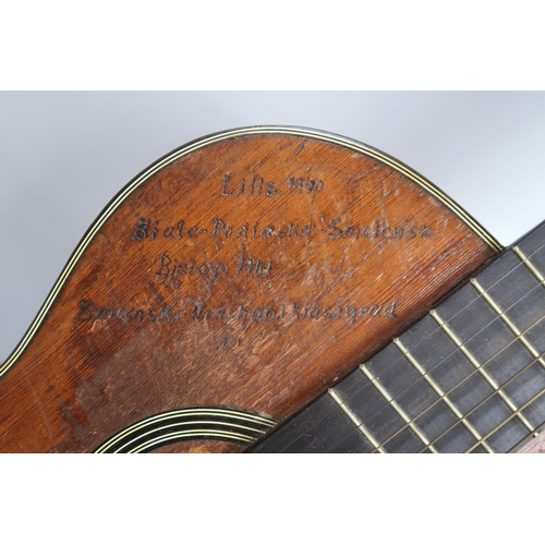 572 - WWII MILITARY INTEREST an acoustic guitar the body bearing an inscribed record of World War II battl... 