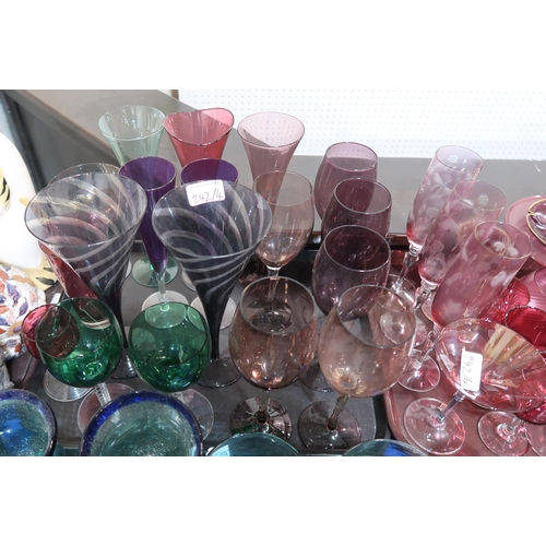 242 - A collection of coloured drinking glasses including ruby, amethyst and green