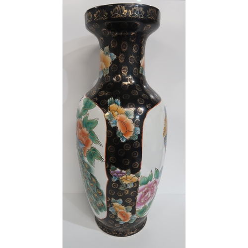 279 - A contemporary Chinese black ground vase, of baluster form, decorated with peacocks, 61cm high