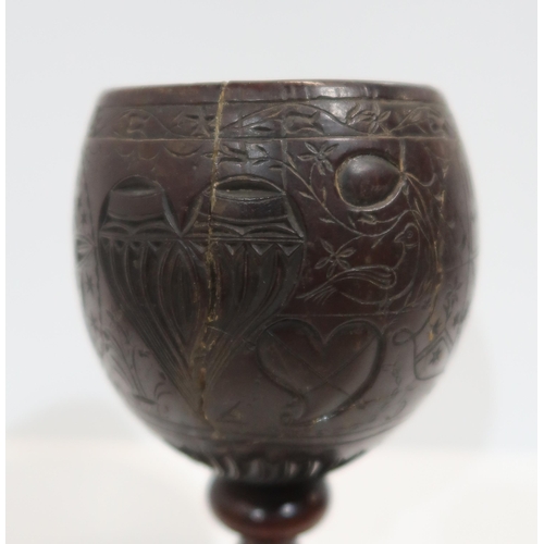 279A - An18th century carved coconut cup, inscribed Joshua Pike, 1780, carved with heart and star motifs, w... 