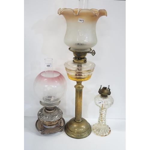 300 - An EP oil lamp with etched glass shade, together with two other oil lamps