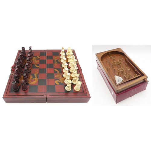 539 - A Chinese resin chess set, together with a Past Times tabletop bagatelle board