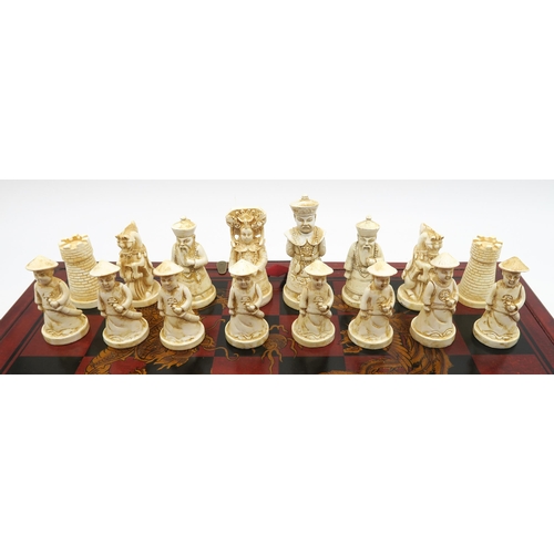 539 - A Chinese resin chess set, together with a Past Times tabletop bagatelle board