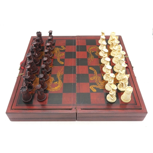 539 - A Chinese resin chess set, together with a Past Times tabletop bagatelle board