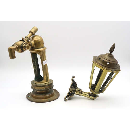 565 - A heavy brass pump head or tap (possibly a beer font), together with a brass wall sconce formed as a... 