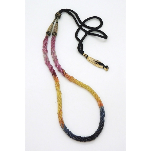 2712 - RAINBOW SAPPHIRE BEADSeach faceted bead is strung in a multi string twisted necklace with traditiona... 