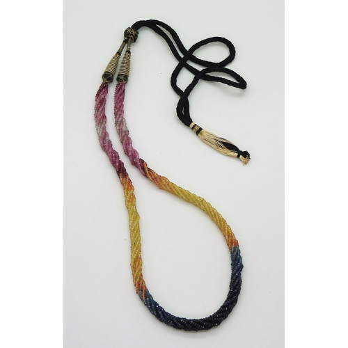 2712 - RAINBOW SAPPHIRE BEADSeach faceted bead is strung in a multi string twisted necklace with traditiona... 