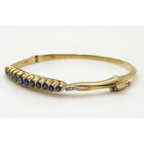 2719 - A SAPPHIRE AND DIAMOND BANGLEwith 9ct gold hallmarks for London 1987. Inner diameter 5.7cm x 5.2cm, ... 