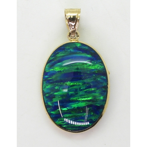 2722 - A 14K DOLPHIN PENDANTset with a large piece of man made opal of approx 2.4cm x 1.8cm, length of pend... 