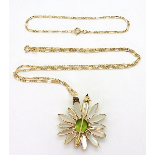 2728 - A MOONSTONE AND PERIDOT FLOWERmounted in 18ct gold to be worn as a pendant or brooch, stamped with t... 