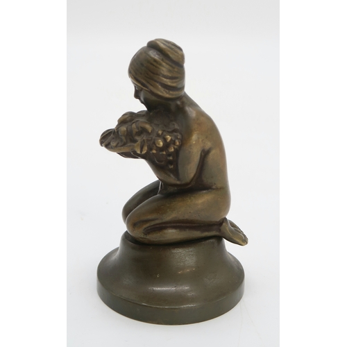 2175 - AN ART DECO BRONZE OF A GIRLmodelled kneeling holding a bowl of flowers and fruit, 14.5cm high, toge... 